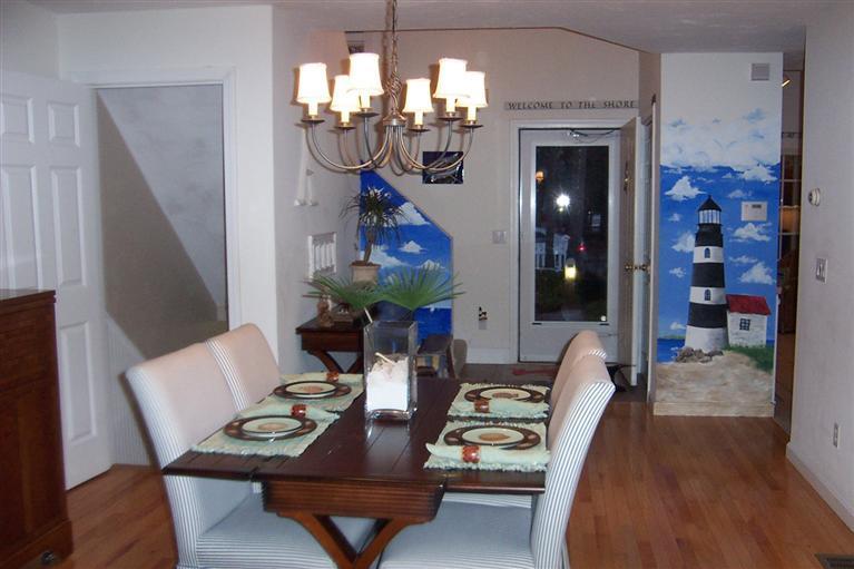 16 Gold Leaf Lane, Unit 16 Mashpee, MA 02649 - Photo 13 of 29 a view of a dining room with furniture a chandelier and wooden floor