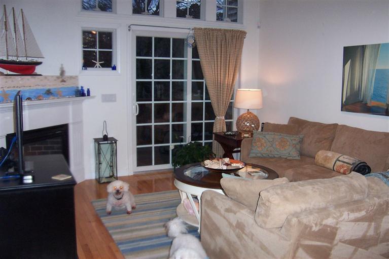 16 Gold Leaf Lane, Unit 16 Mashpee, MA 02649 - Photo 15 of 29 a living room with furniture a fireplace and a flat screen tv