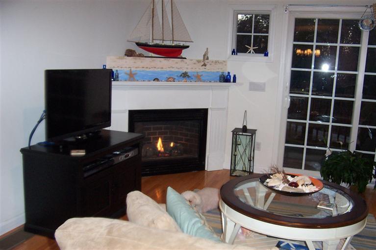 16 Gold Leaf Lane, Unit 16 Mashpee, MA 02649 - Photo 16 of 29 a living room with furniture a flat screen tv and a fireplace