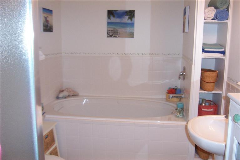 16 Gold Leaf Lane, Unit 16 Mashpee, MA 02649 - Photo 18 of 29 a bathroom with a bathtub and a shower