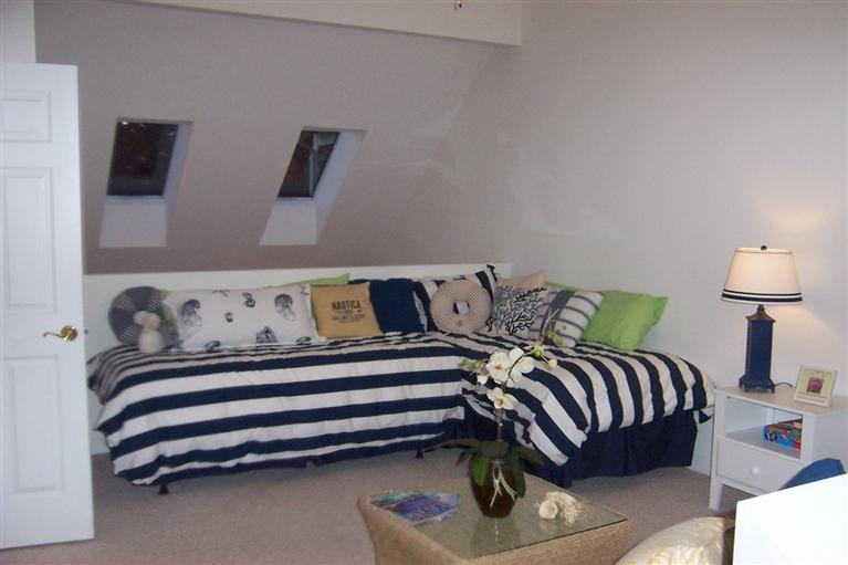 16 Gold Leaf Lane, Unit 16 Mashpee, MA 02649 - Photo 19 of 29 a bedroom with a bed and a night stand