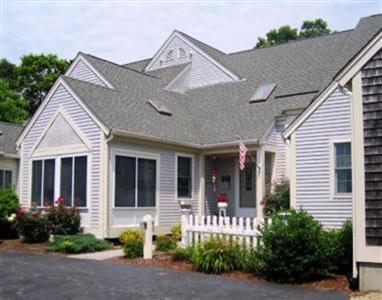 16 Gold Leaf Lane, Unit 16 Mashpee, MA 02649 - Photo 2 of 29 a front view of a house with garden