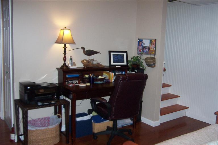 16 Gold Leaf Lane, Unit 16 Mashpee, MA 02649 - Photo 26 of 29 a living room with furniture and a lamp
