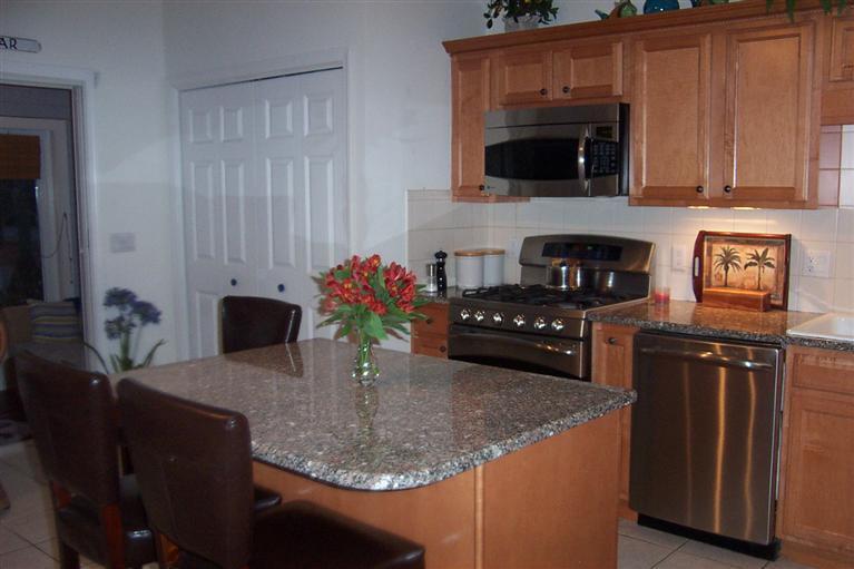 16 Gold Leaf Lane, Unit 16 Mashpee, MA 02649 - Photo 10 of 29 a kitchen with granite countertop a stove and a microwave