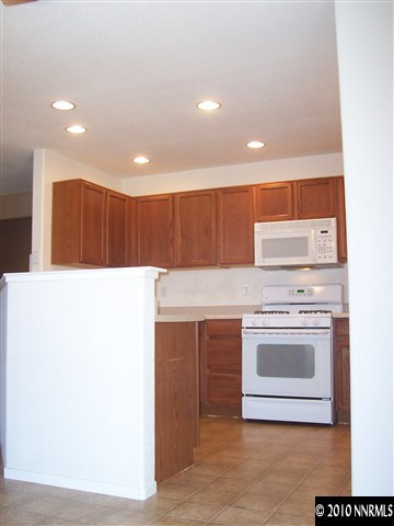 7651 Corso Street Reno, NV 89506 - Photo 5 of 6 a kitchen with a stove a sink and a microwave