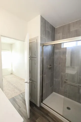 a bathroom with a glass shower door