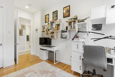 a view of a kitchen with stainless steel appliances kitchen island granite countertop a refrigerator and a stove top oven