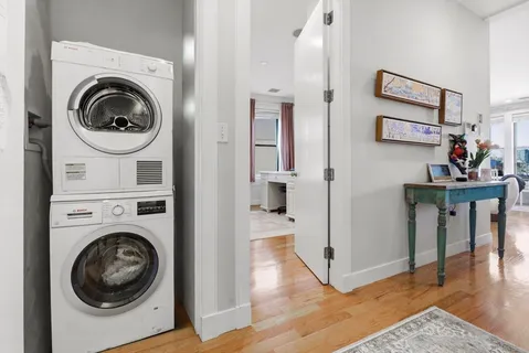 a view of a hallway with washer and dryer