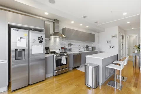a kitchen with cabinets and stainless steel appliances