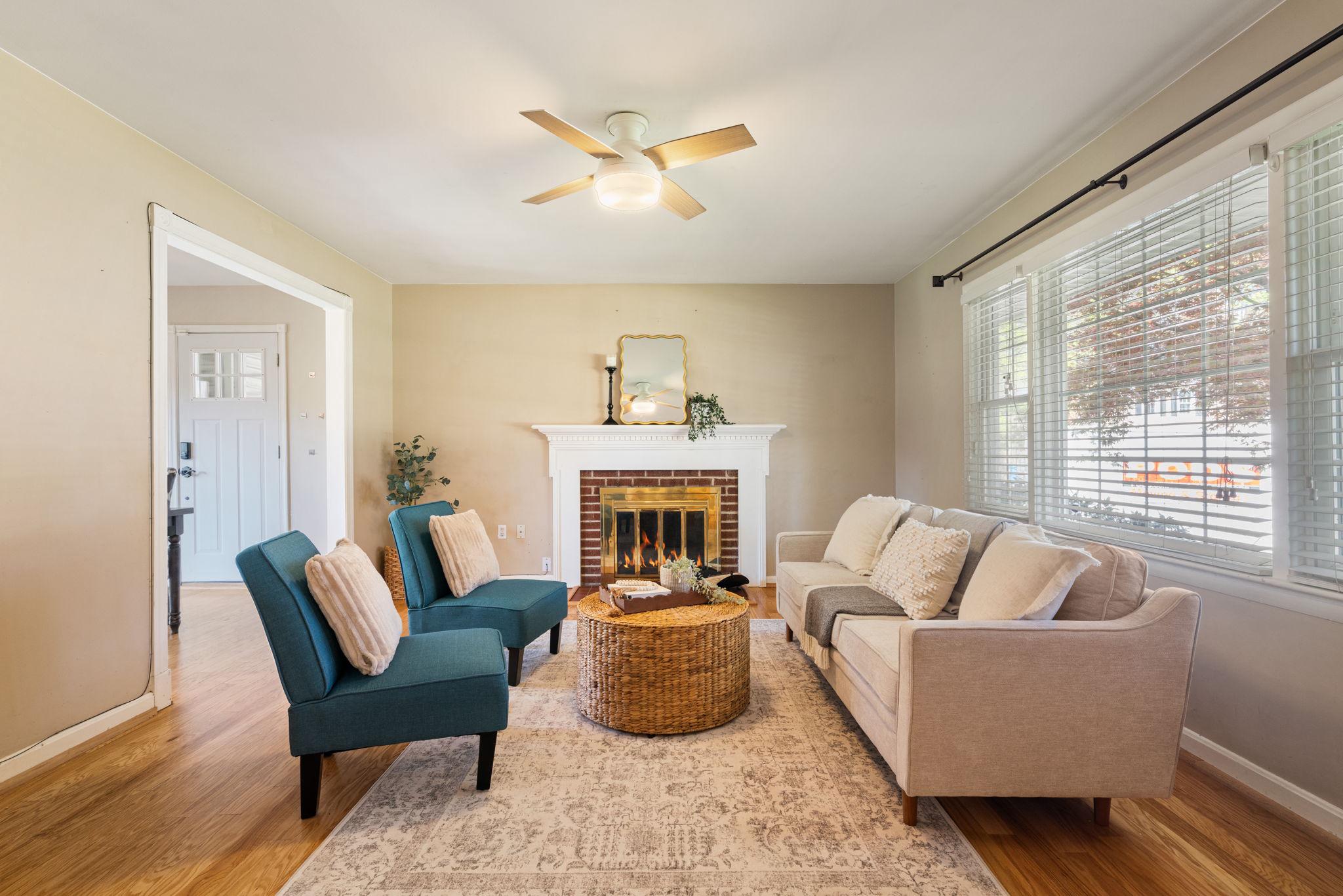 7600 Kingsbury Road Alexandria, VA 22315 - Photo 4 of 31 a living room with furniture a fireplace and a large window