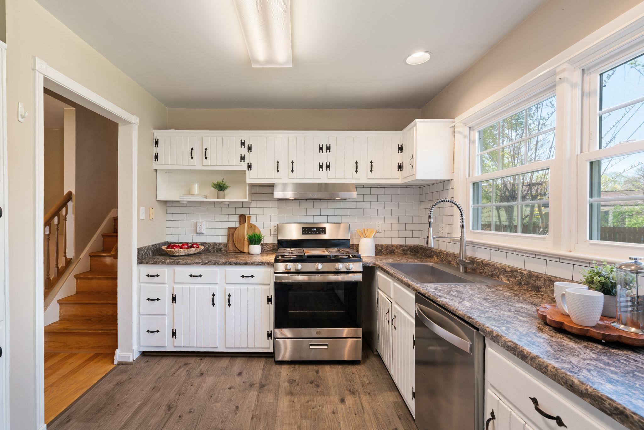 7600 Kingsbury Road Alexandria, VA 22315 - Photo 9 of 31 a kitchen with stainless steel appliances granite countertop a stove and white cabinets