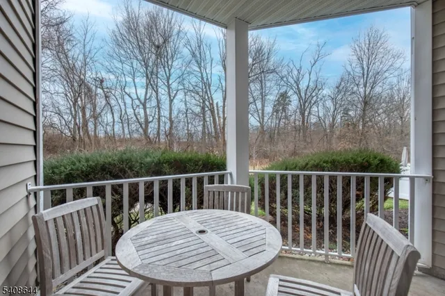 a view of a chair and table in the balcony