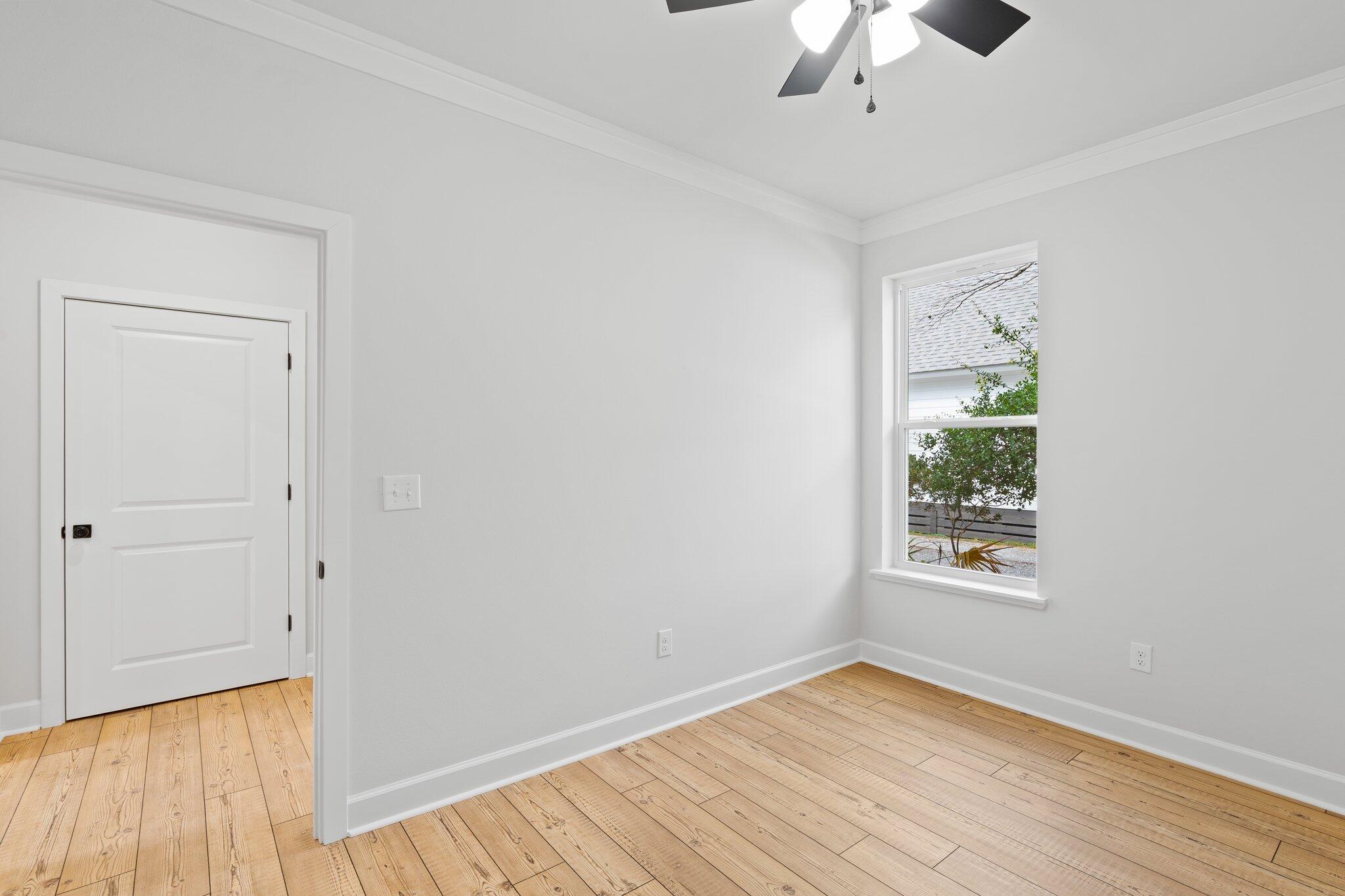 45 Laurel Oak Lane Santa Rosa Beach, FL 32459 - Photo 29 of 30 a view of an empty room with wooden floor and a window