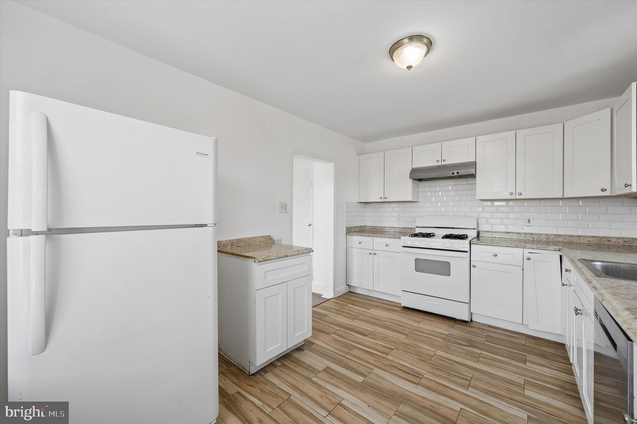 59 Houston Road Lansdowne, PA 19050 - Photo 13 of 24 a kitchen with white cabinets and white appliances