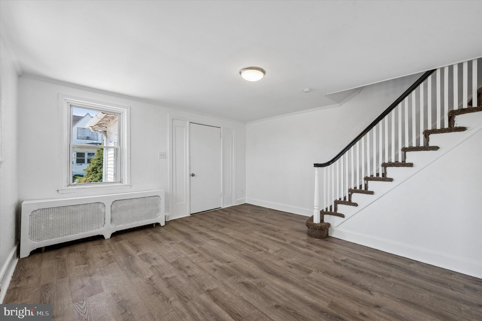 59 Houston Road Lansdowne, PA 19050 - Photo 6 of 24 a view of an empty room with wooden floor and a window