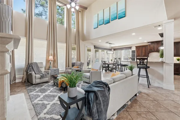 a view of a dining room with furniture a kitchen and chandelier
