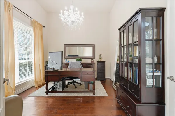 a view of a workspace with furniture and a window