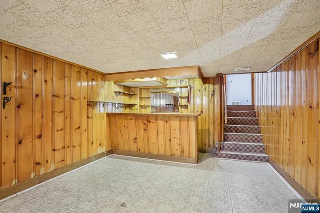a view of a kitchen with stainless steel appliances wooden cabinets and table