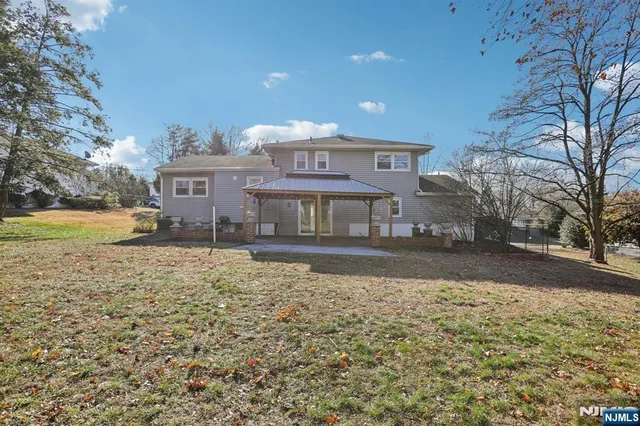 a view of a house with a yard covered in snow