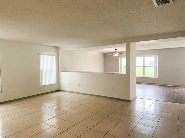 an empty room with windows and entrance