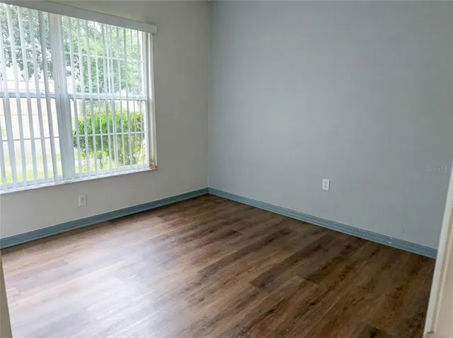 a living room with furniture a flat screen tv and a large window