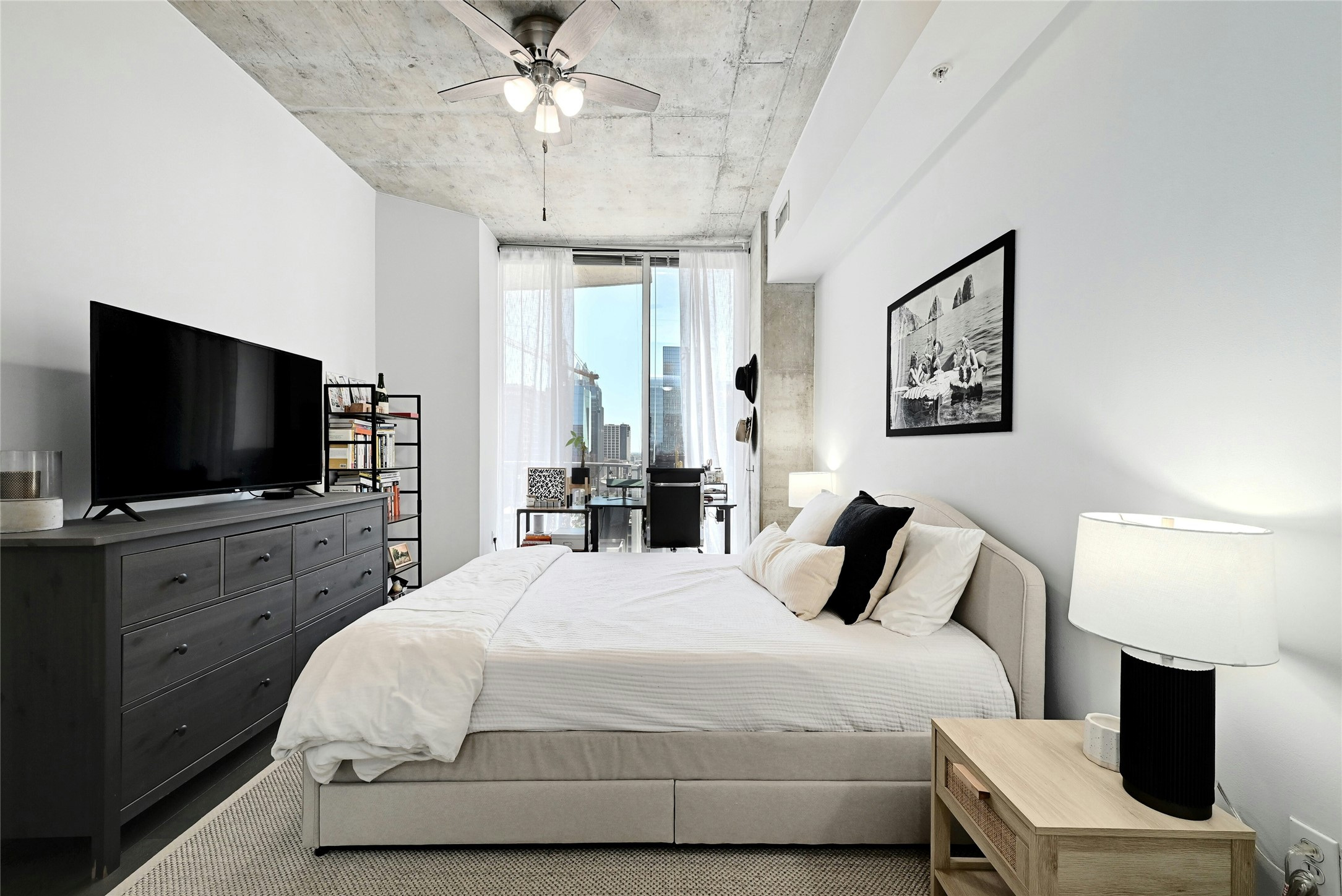 360 Nueces Street, Unit 1809 Austin, TX 78701 - Photo 18 of 25 Bedroom featuring a concrete ceiling, ceiling fan with integrated lighting, full-height windows, and light-toned walls