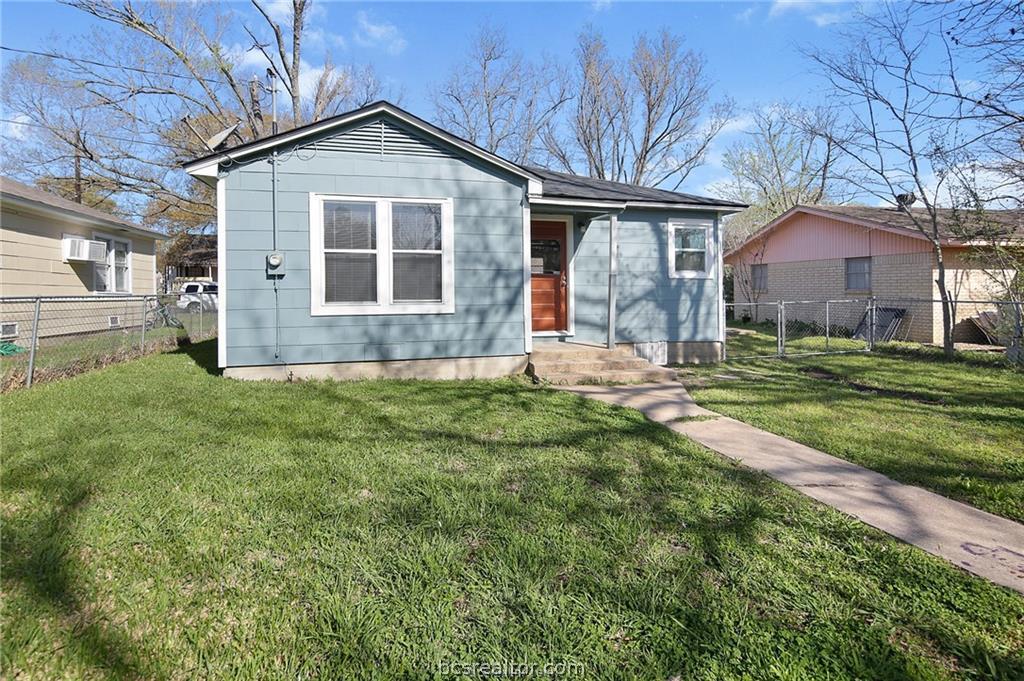 1504 Baker Avenue Bryan, TX 77803 - Photo 16 of 17 a front view of a house with a yard and garage