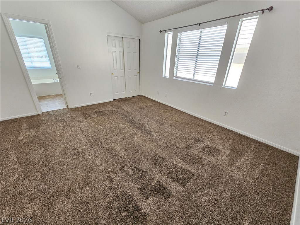 2817 Albemarle Way Henderson, NV 89014 - Photo 21 of 25 A well-proportioned bedroom with vaulted ceilings and ample natural light.