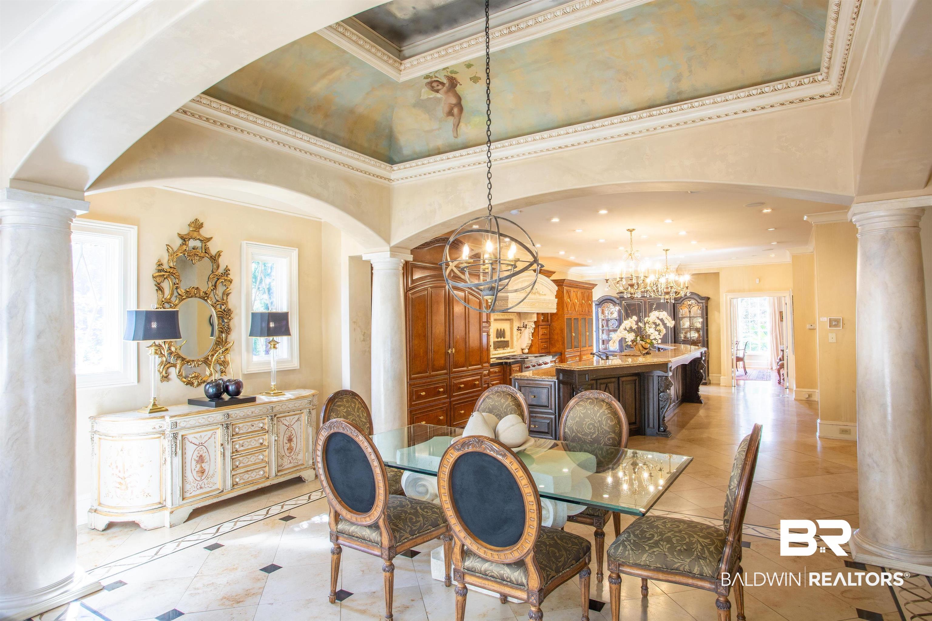 150 Austill Avenue Mobile, AL 36608 - Photo 23 of 39 Formal dining space featuring a painted tray ceiling, decorative archways, and a unique spherical chandelier