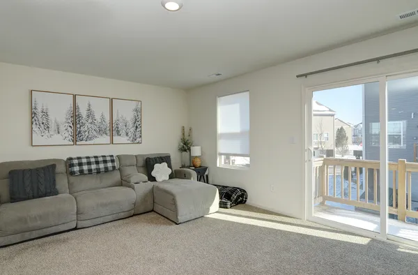 a living room with furniture and a large window