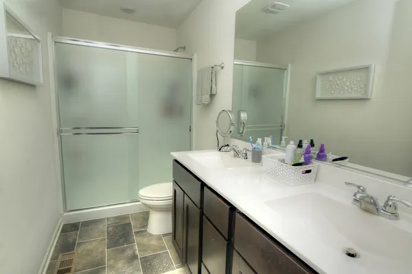 a bathroom with a sink toilet and shower