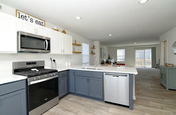 a kitchen with a sink stove and microwave