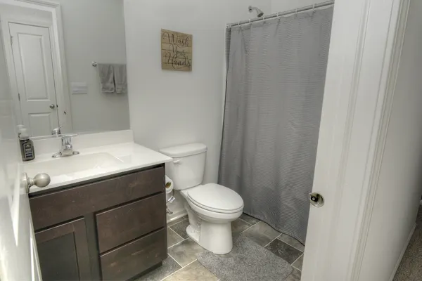 a bathroom with a sink toilet and a mirror