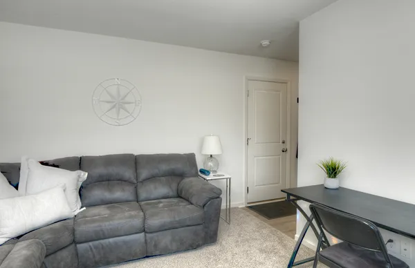 a living room with furniture and a potted plant