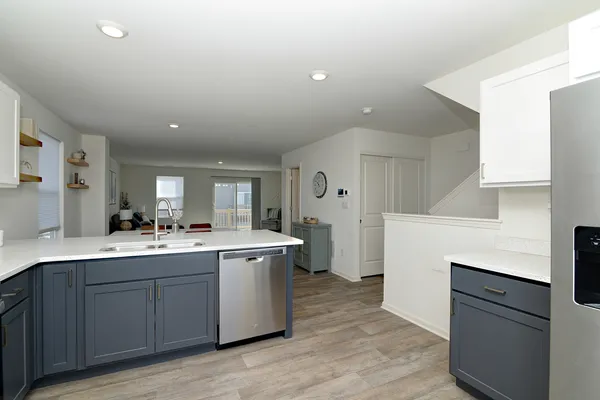 a kitchen with a sink cabinets and wooden floor