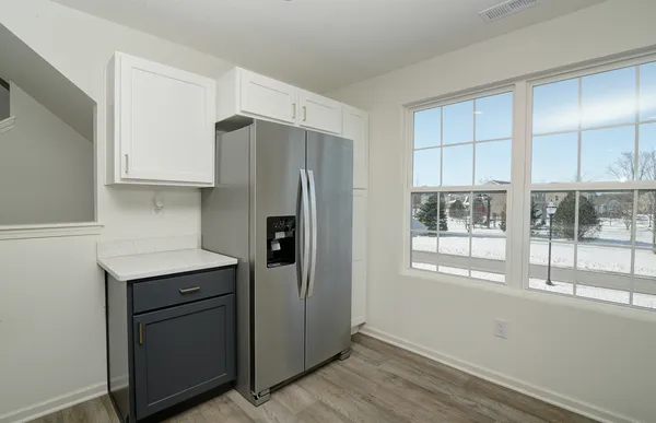 a kitchen with a refrigerator a sink and cabinets