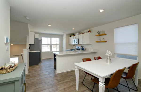 a kitchen with a table and chairs in it