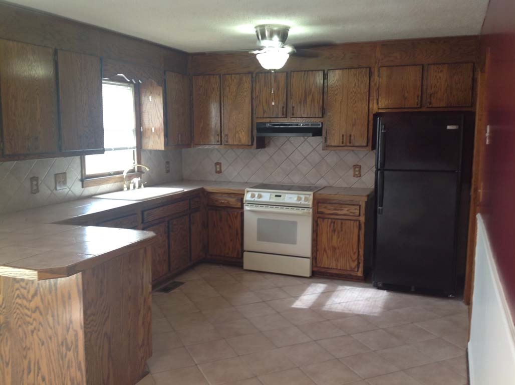 131 Buckboard Road Waynesboro, VA 22980 - Photo 3 of 17 a kitchen with a sink a stove a refrigerator and cabinets