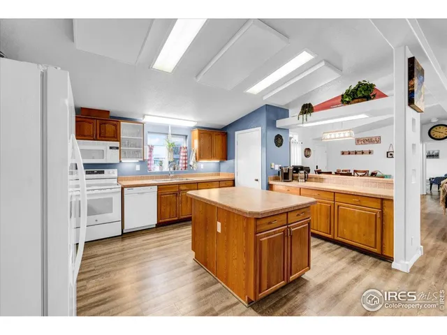 a kitchen with a sink stove top oven and refrigerator