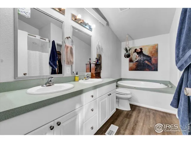 a bathroom with a granite countertop sink toilet and a bathtub