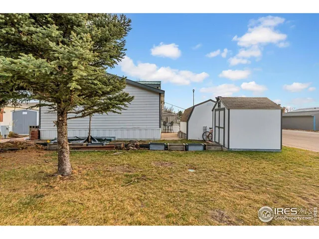 a view of a swimming pool with a chair and a fire pit