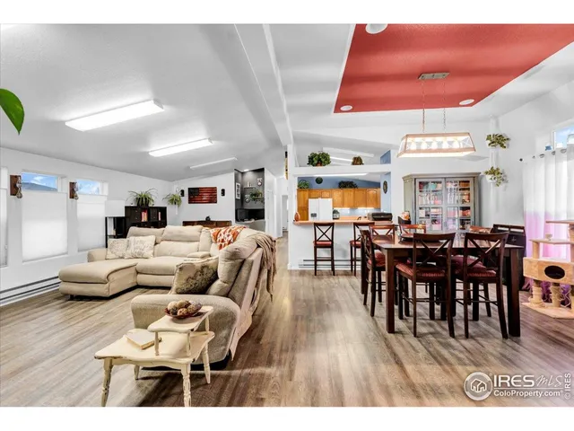 a living room with lots of furniture and a large window