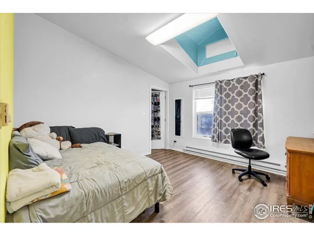 a bedroom with a bed a desk and chair