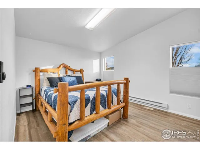 a bedroom with furniture and a wooden floor