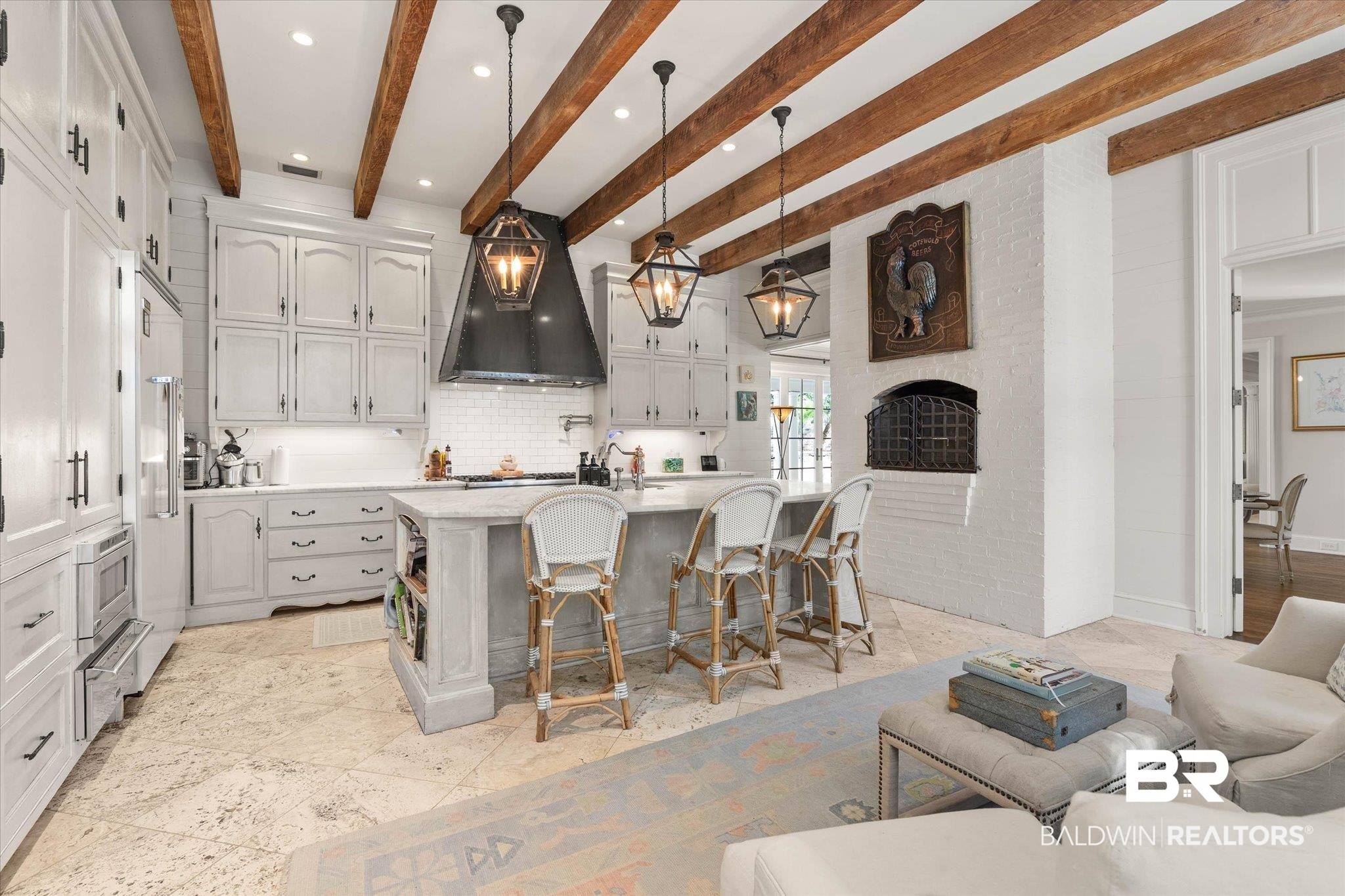 2256 De Leon Avenue Mobile, AL 36607 - Photo 13 of 61 Kitchen featuring a center island with sink, a kitchen bar, hanging light fixtures, light stone countertops, and decorative backsplash