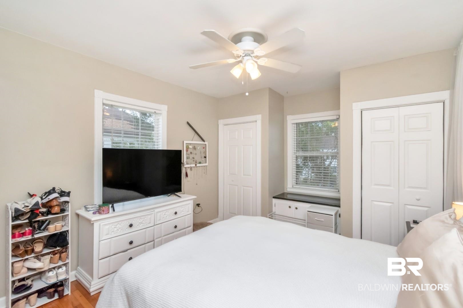 214 Upham Street, Unit 17C Mobile, AL 36607 - Photo 26 of 32 Bedroom with multiple closets, light wood-style flooring, and ceiling fan