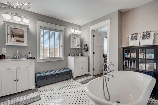 24076 Kobilan Road Calhan, CO 80808 - Photo 19 of 50 Bathroom with a bath to relax in and vanity