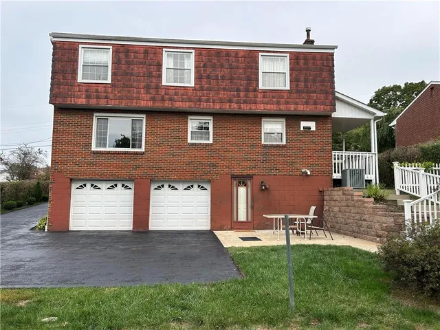 a view of a backyard with sitting area