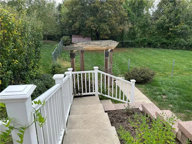 a view of a house with a yard and a garden