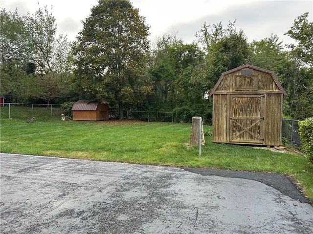 a view of a house with a backyard